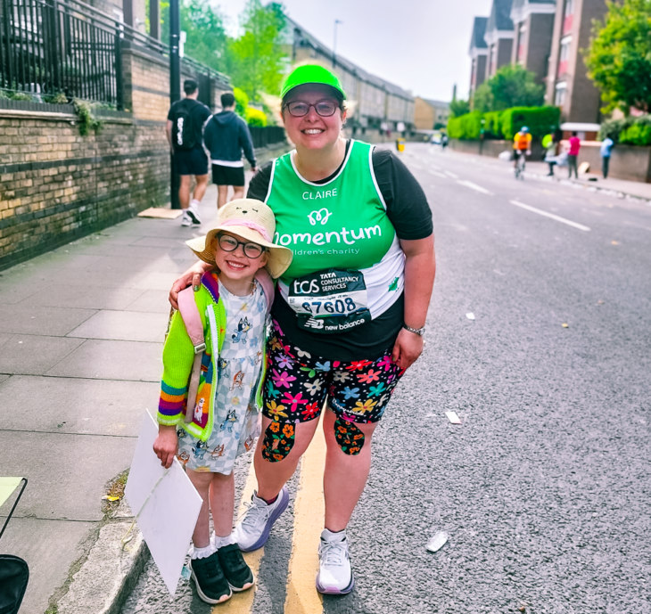 A young girl in a hat and a woman wearing a Momentum Children's Charity running vest pose at The London Marathon