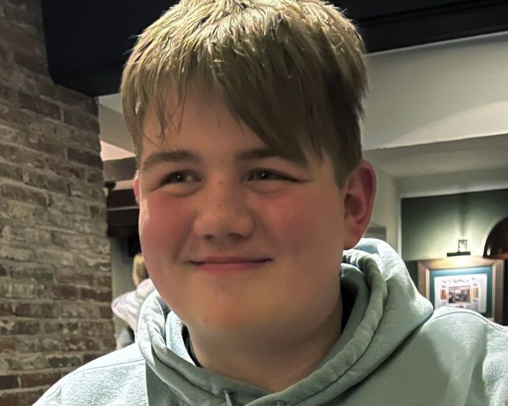 A teenage boy smiling.