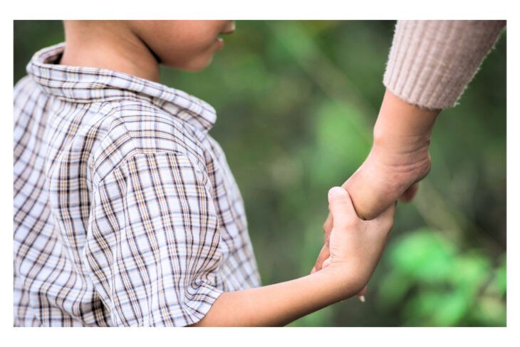 parent holding a childs hand for Free Wills Month