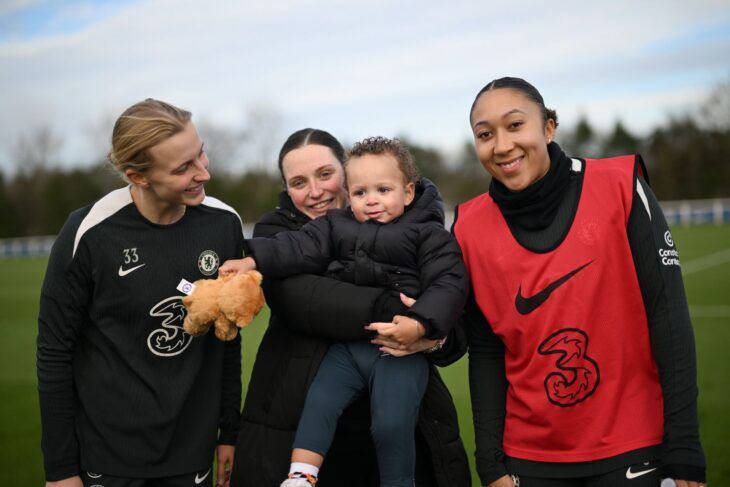 Chelsea FC players with a Momentum-supported family.