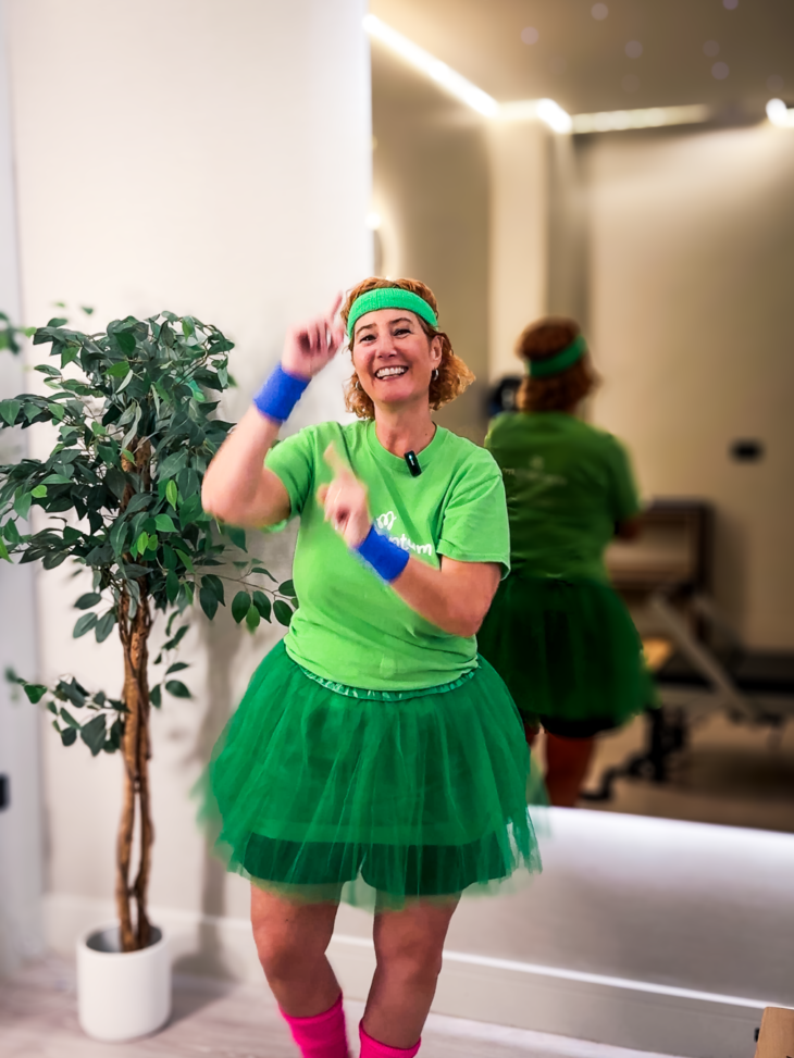 Momentum CEO in preparation for 24 hour Danceathon wearing green tutu, leg warmers and sweat bands.