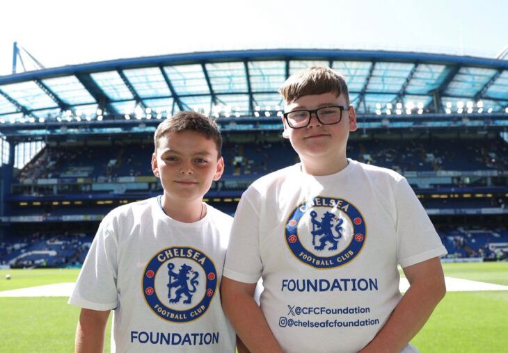 Two brothers wear their Chelsea FC shirts as they visit the famous football stadium