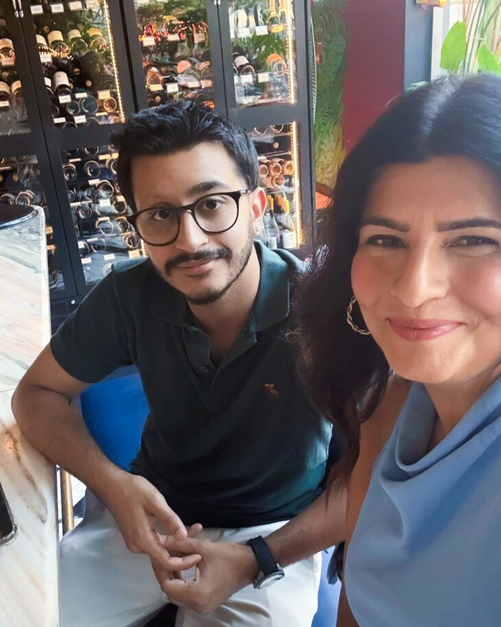 A mother and son who were supported by Momentum sit together.