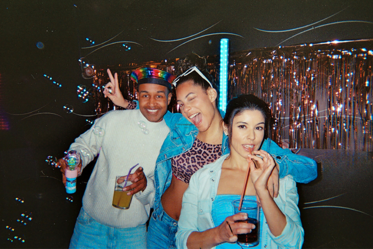 Three adults enjoying a dance party