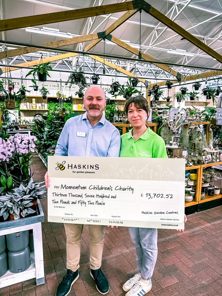 Nick from Haskins and Amy from Momentum at Haskins Garden Centre with a large cheque