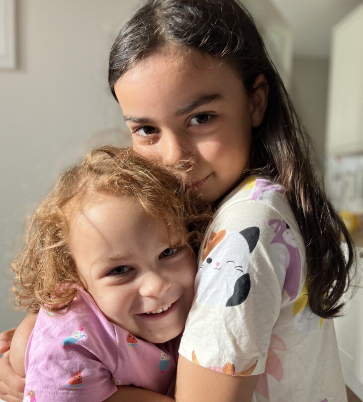 Two siblings embrace