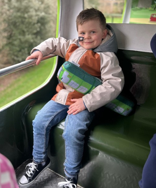 Supported child on a bus during a Momentum Children's Charity outing